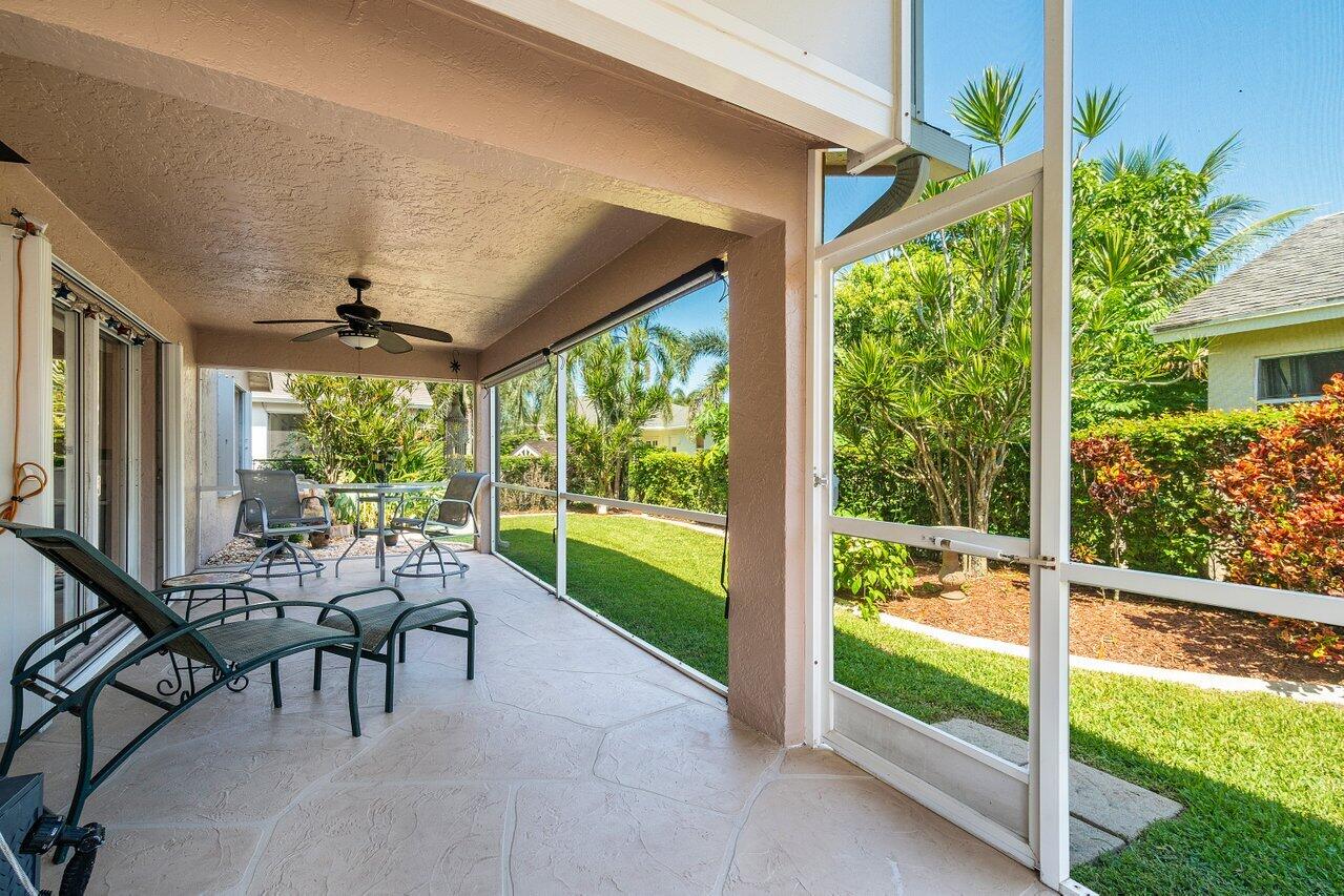 1410 Bethpage Way Greenacres, FL 33413 - Photo 22 of 29 a view of a patio with table and chairs potted plants with floor to ceiling windows