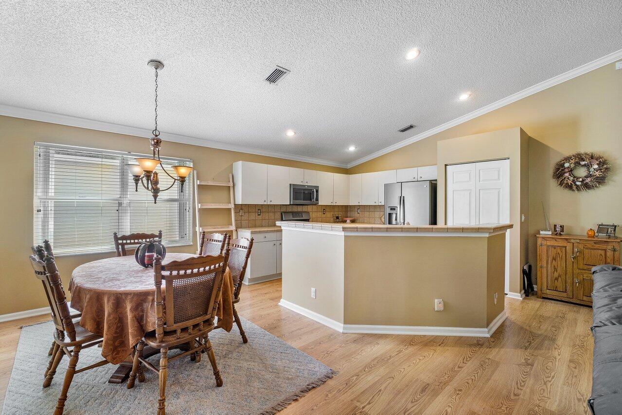 1410 Bethpage Way Greenacres, FL 33413 - Photo 10 of 29 a dining room with furniture and kitchen view