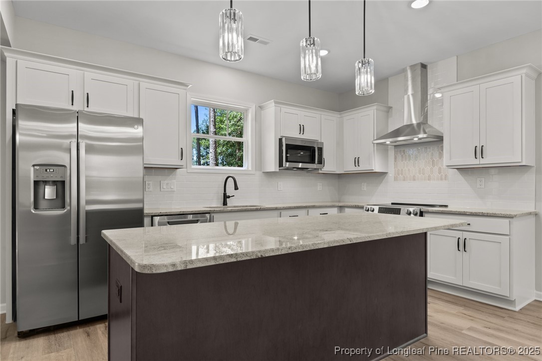 15980 Old Orchard Court Wagram, NC 28396 - Photo 10 of 33 a kitchen with stainless steel appliances granite countertop a sink a stove a refrigerator cabinets and chairs