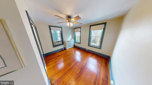 a view of an entryway with wooden floor and door