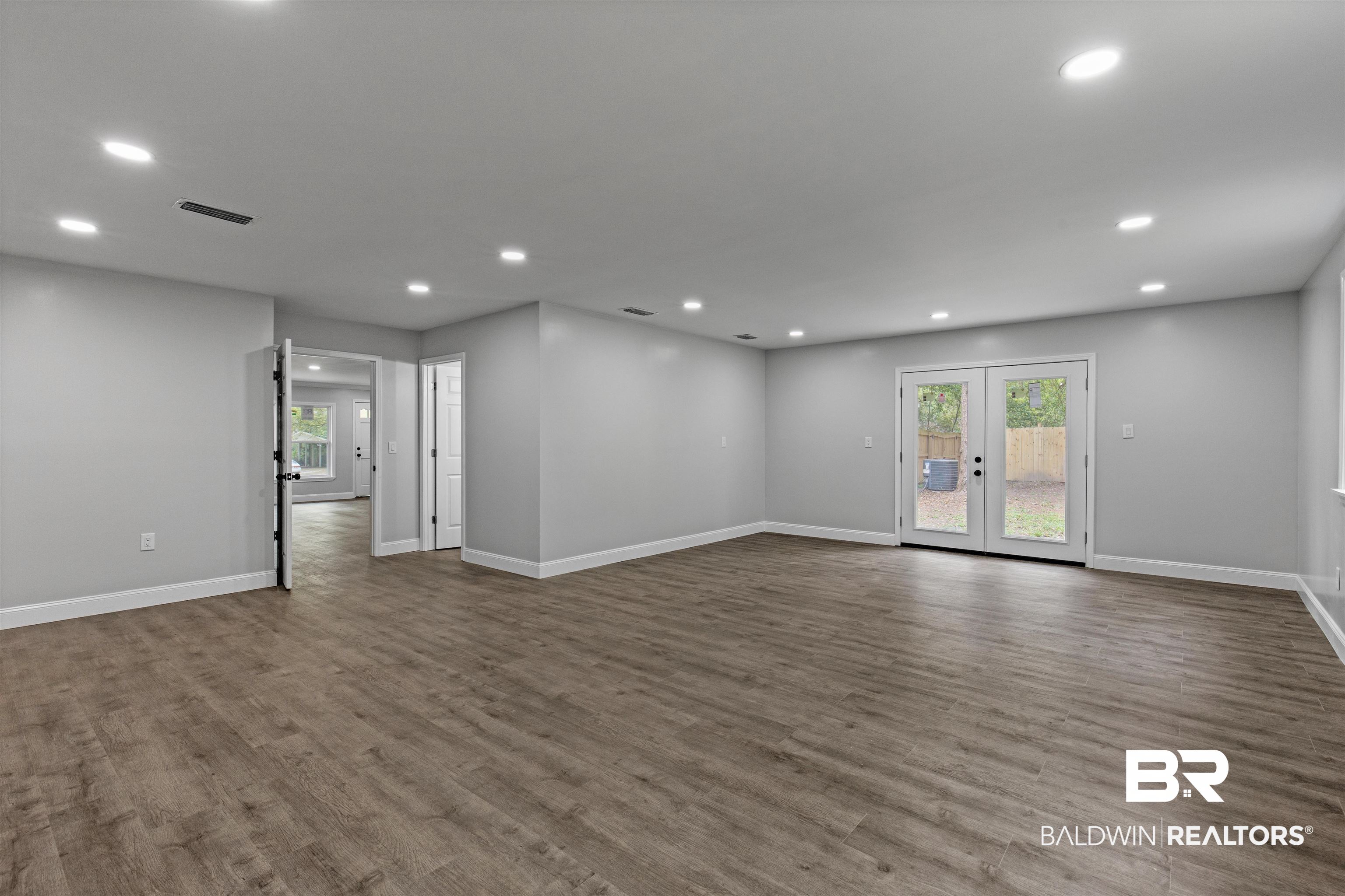 1432 South Polaris Drive Mobile, AL 36693 - Photo 16 of 27 Unfurnished room with plenty of natural light, dark wood-type flooring, french doors, and recessed lighting