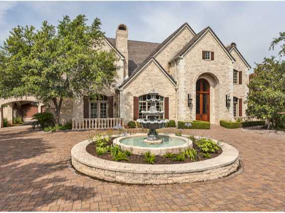 a view of a house with fountain bath tub and fire pit