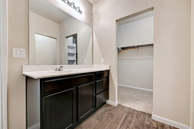 an empty room with ceiling fan and window