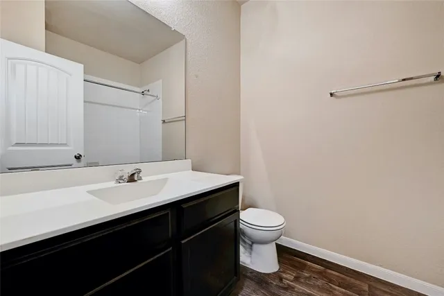 an empty room with a chandelier fan and windows