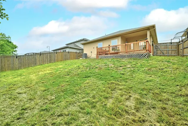 a view of a deck with wooden floor and fence