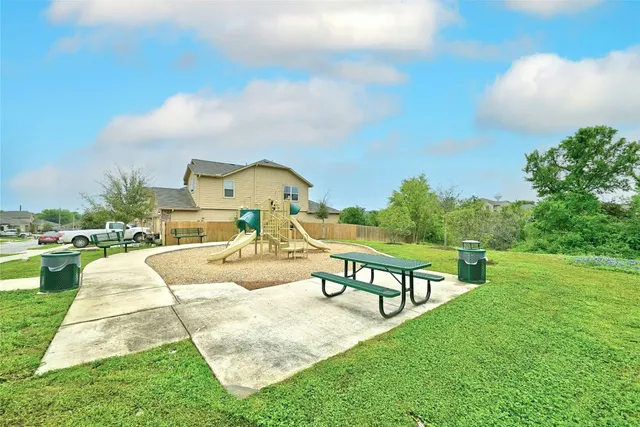 a view of a backyard with a garden and deck