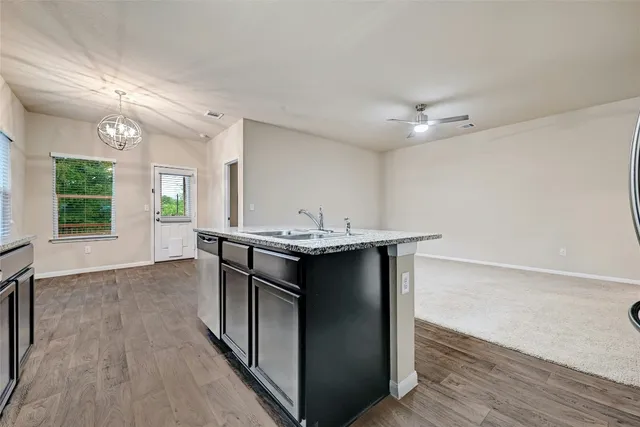 a kitchen with stainless steel appliances granite countertop a refrigerator stove microwave and sink