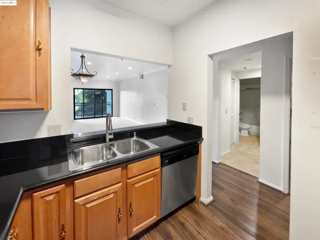 a kitchen with granite countertop a sink and cabinets