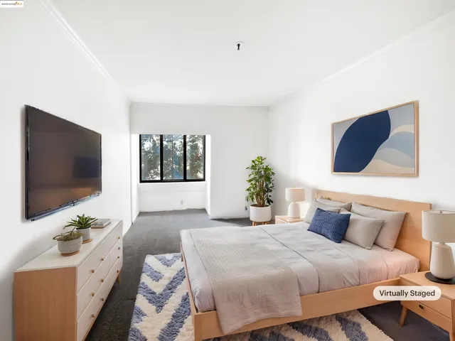 a bedroom with a large bed and a flat screen tv