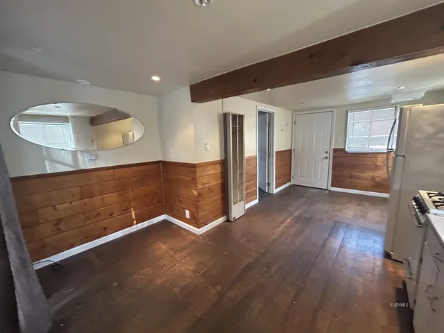 a view of a kitchen with a sink refrigerator and a window