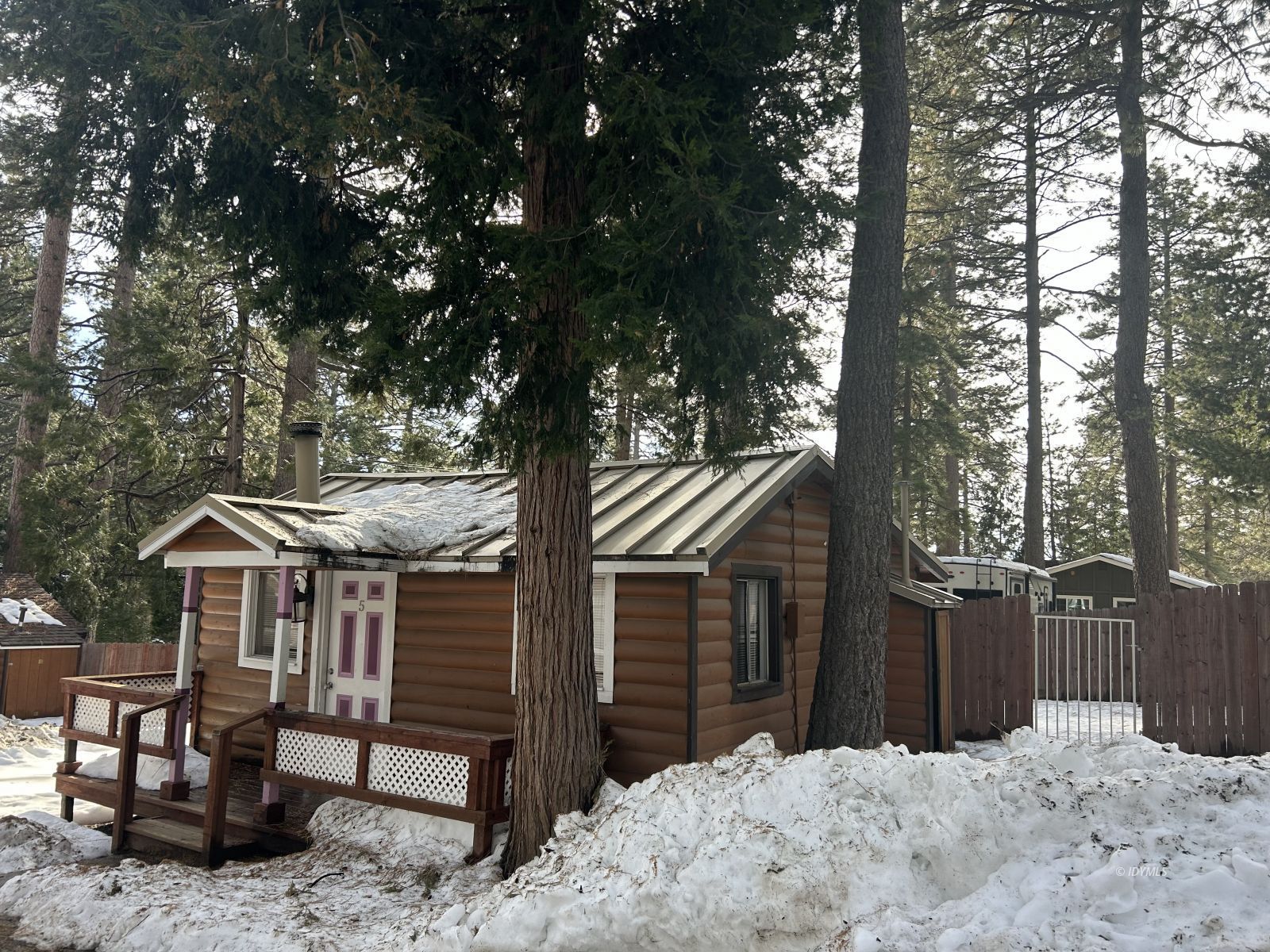 25055 Marion Ridge Drive, Unit 5 Idyllwild, CA 92549 - Photo 2 of 15 a front view of a house with a yard covered in snow