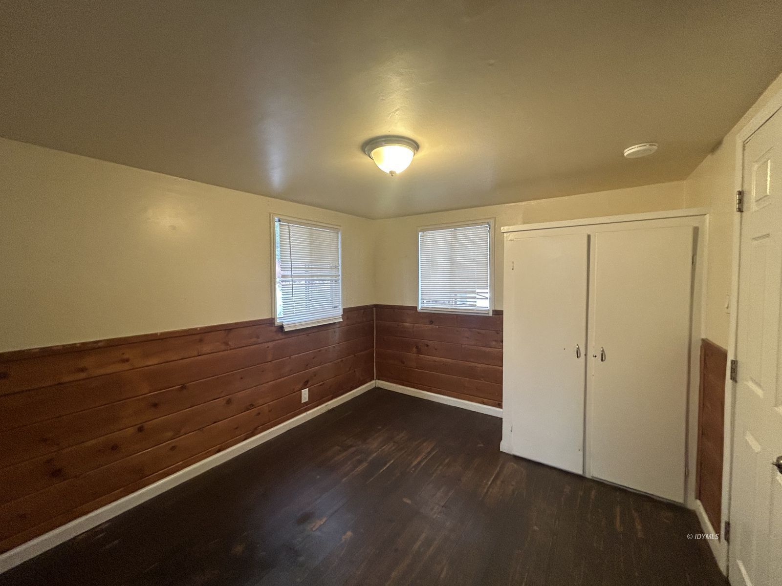 25055 Marion Ridge Drive, Unit 5 Idyllwild, CA 92549 - Photo 6 of 15 an empty room with wooden floor and windows