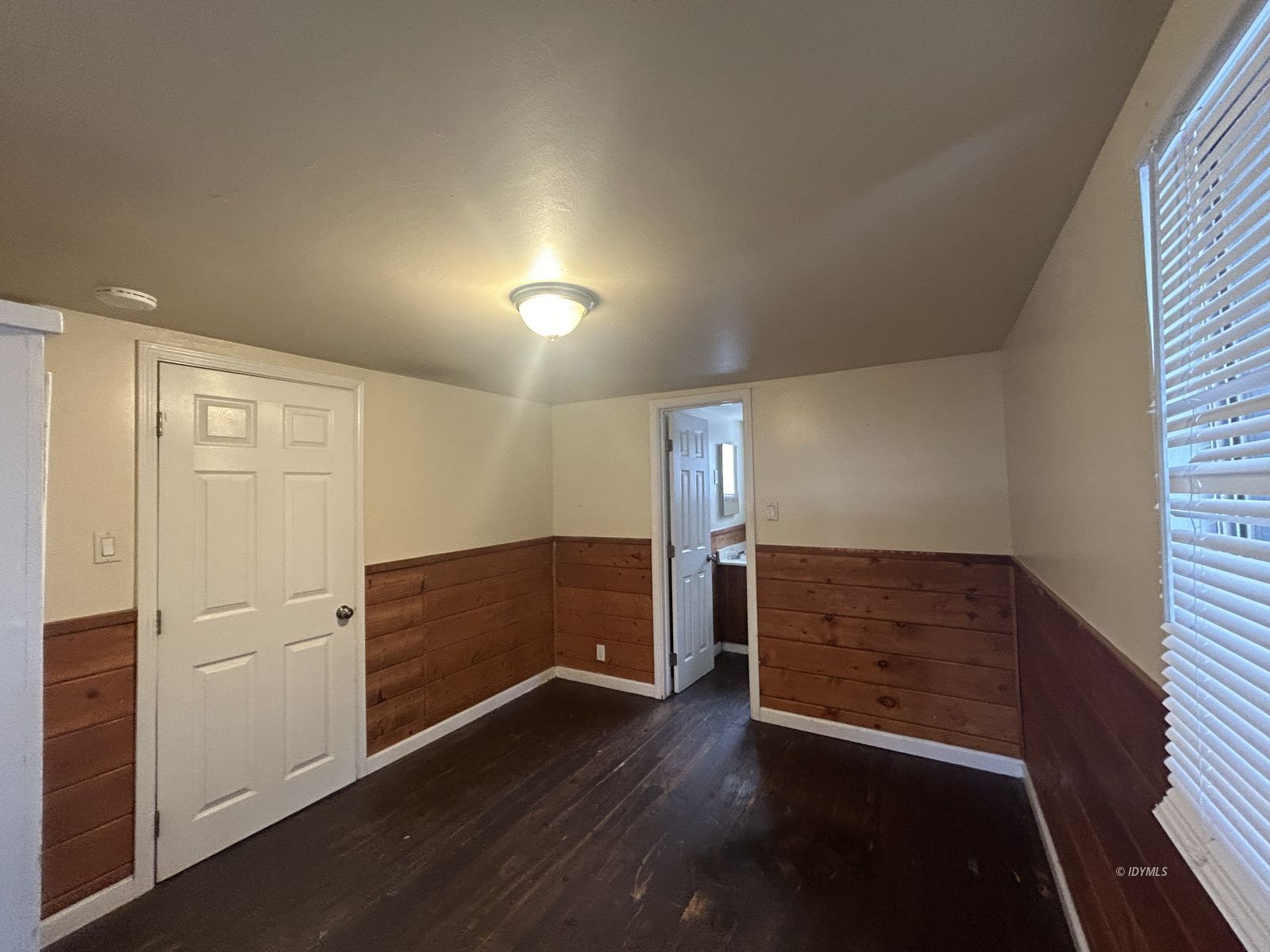 25055 Marion Ridge Drive, Unit 5 Idyllwild, CA 92549 - Photo 7 of 15 an empty room with wooden floor cabinet and windows