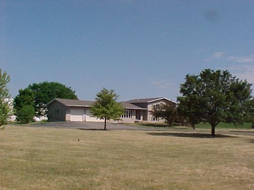 9-n047 Barron Road Maple Park, IL 60151 - Photo 1 of 16 a front view of a house with a yard and a garage