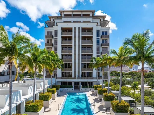 a front view of a multi story building with yard