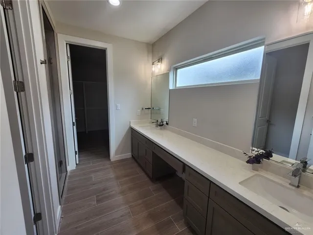 a bathroom with a double vanity sink and a mirror