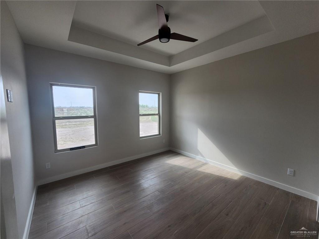 2529 Trinity Avenue McAllen, TX 78504 - Photo 14 of 21 an empty room with wooden floor and windows