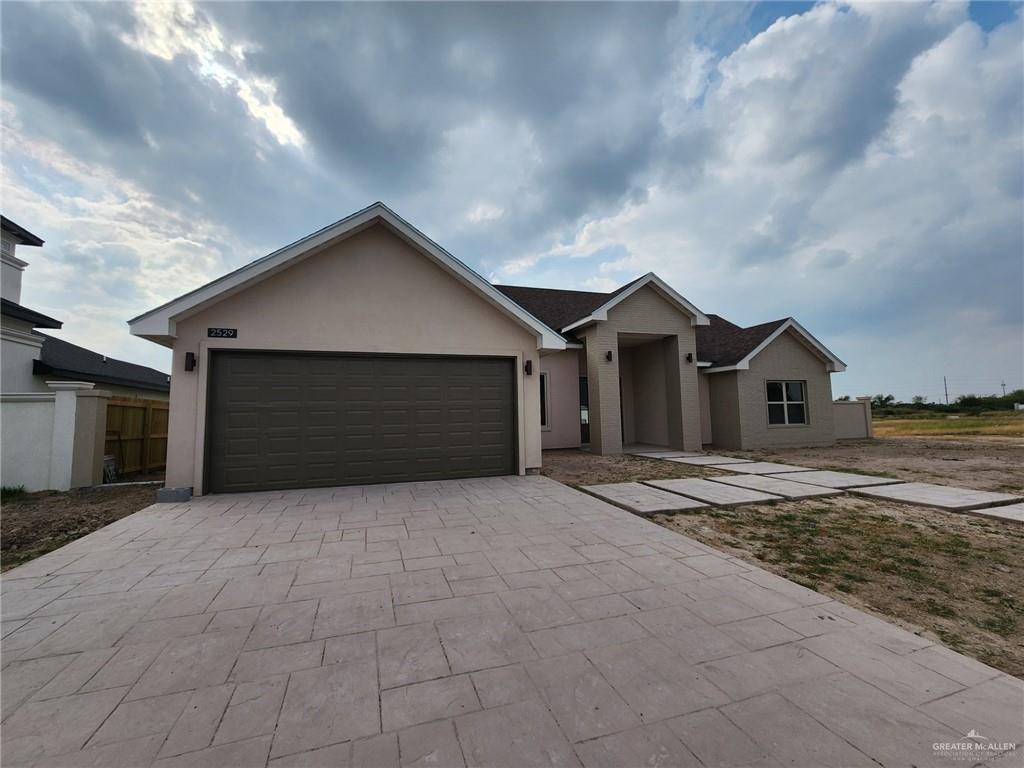 2529 Trinity Avenue McAllen, TX 78504 - Photo 2 of 21 a front view of house with yard and garage