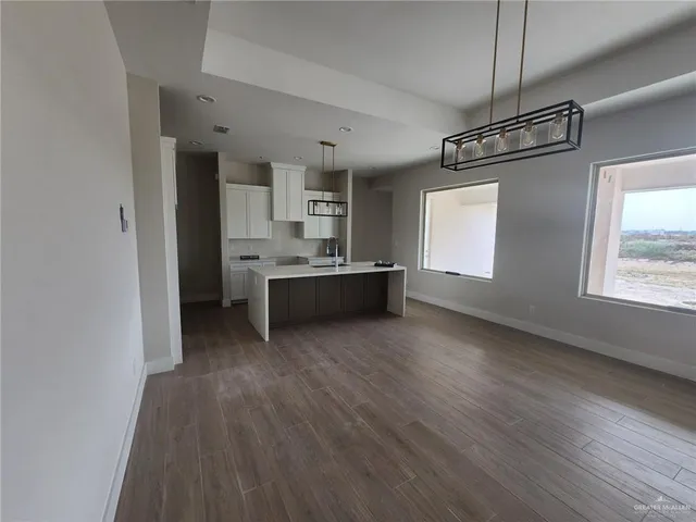 a view of kitchen and kitchen with wooden floor