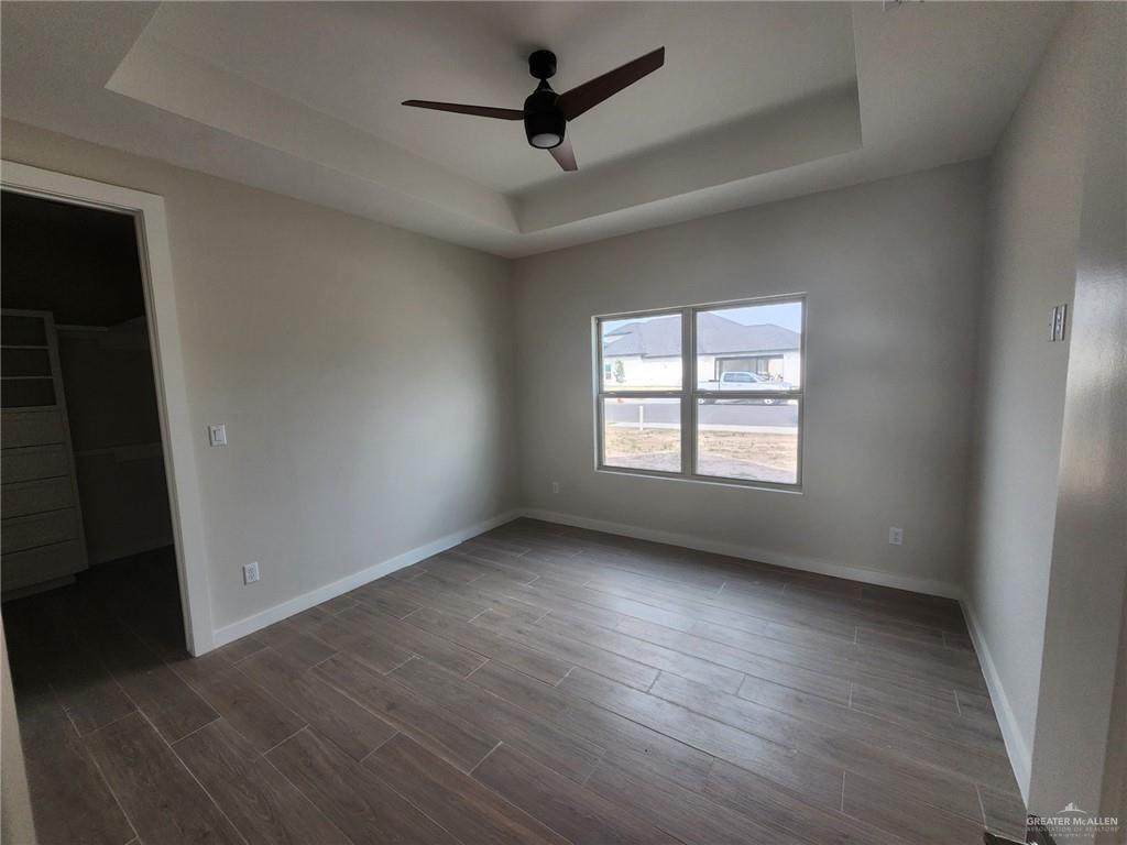 2529 Trinity Avenue McAllen, TX 78504 - Photo 10 of 21 an empty room with wooden floor and windows