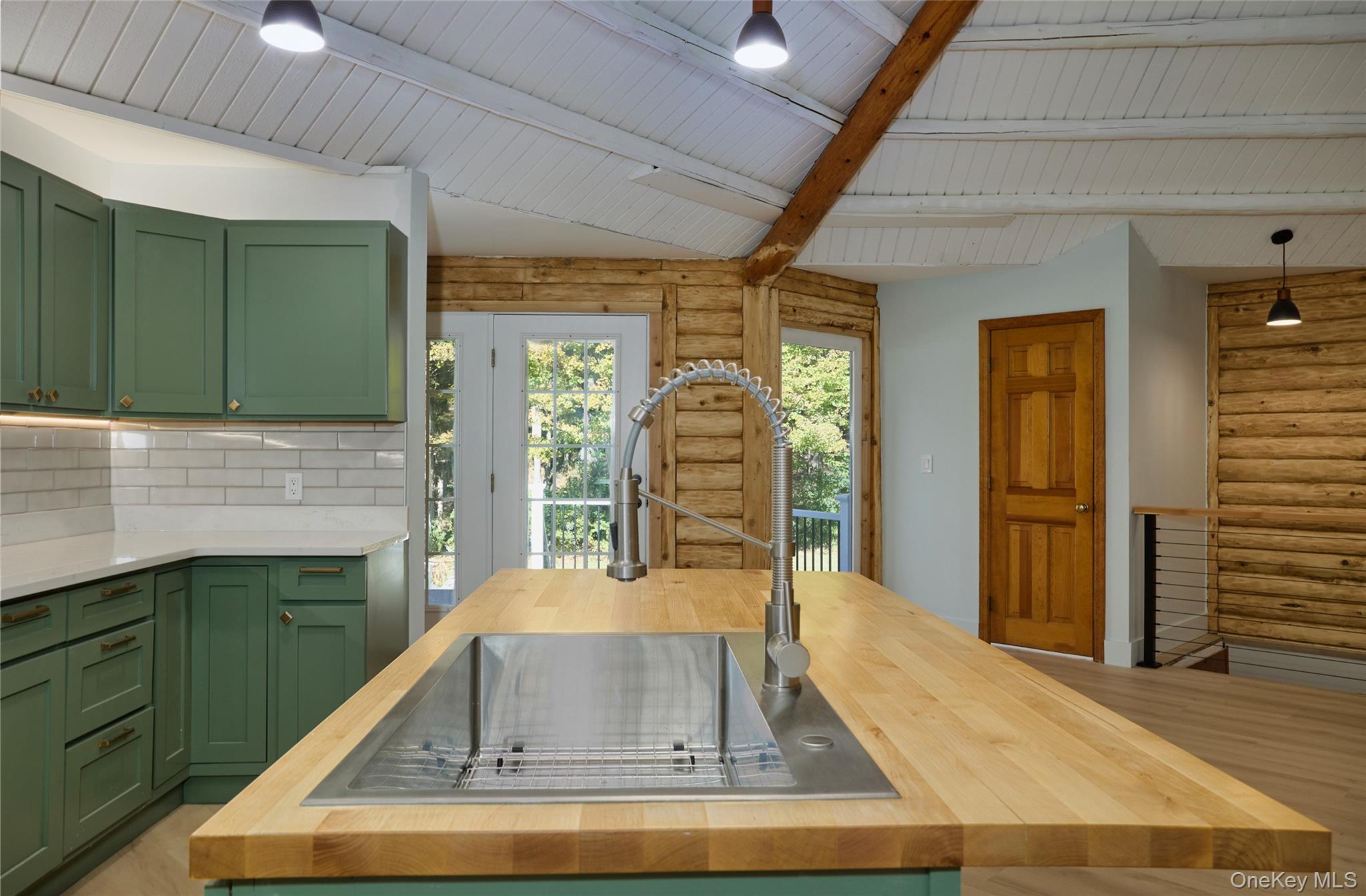 568 Oak Summit Road Millbrook, NY 12545 - Photo 21 of 50 Kitchen with green cabinets, rustic walls, butcher block counters, tasteful backsplash, and a wood ceiling with exposed beams