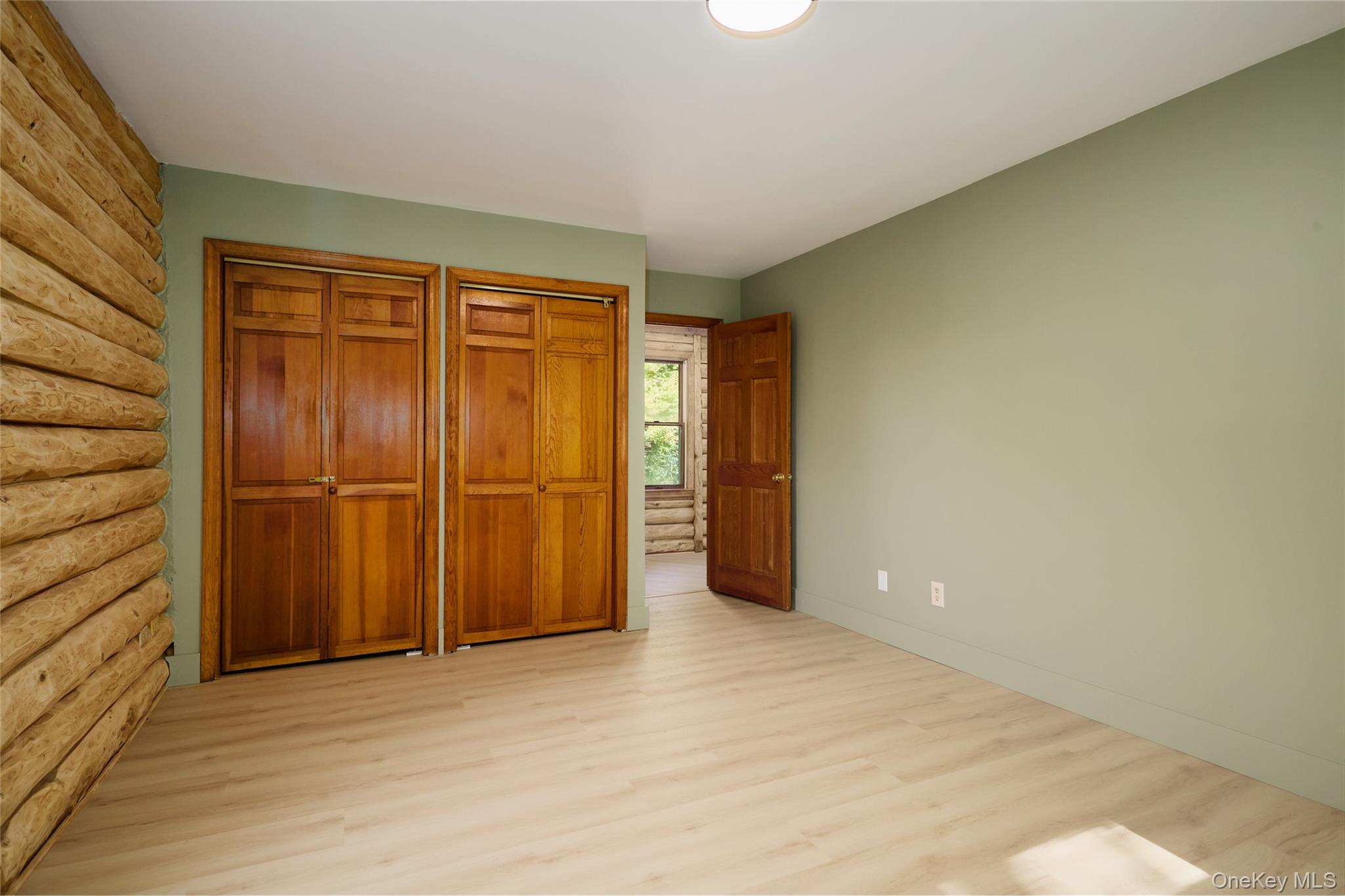 568 Oak Summit Road Millbrook, NY 12545 - Photo 30 of 50 Unfurnished bedroom featuring two closets and light wood finished floors