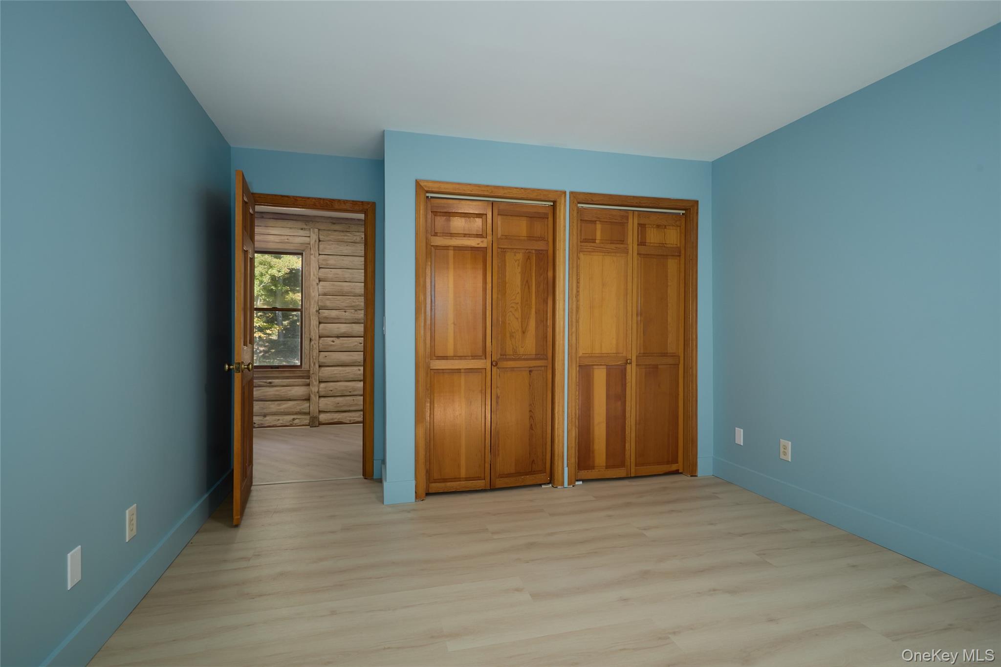 568 Oak Summit Road Millbrook, NY 12545 - Photo 33 of 50 Unfurnished bedroom with light wood-type flooring and multiple closets