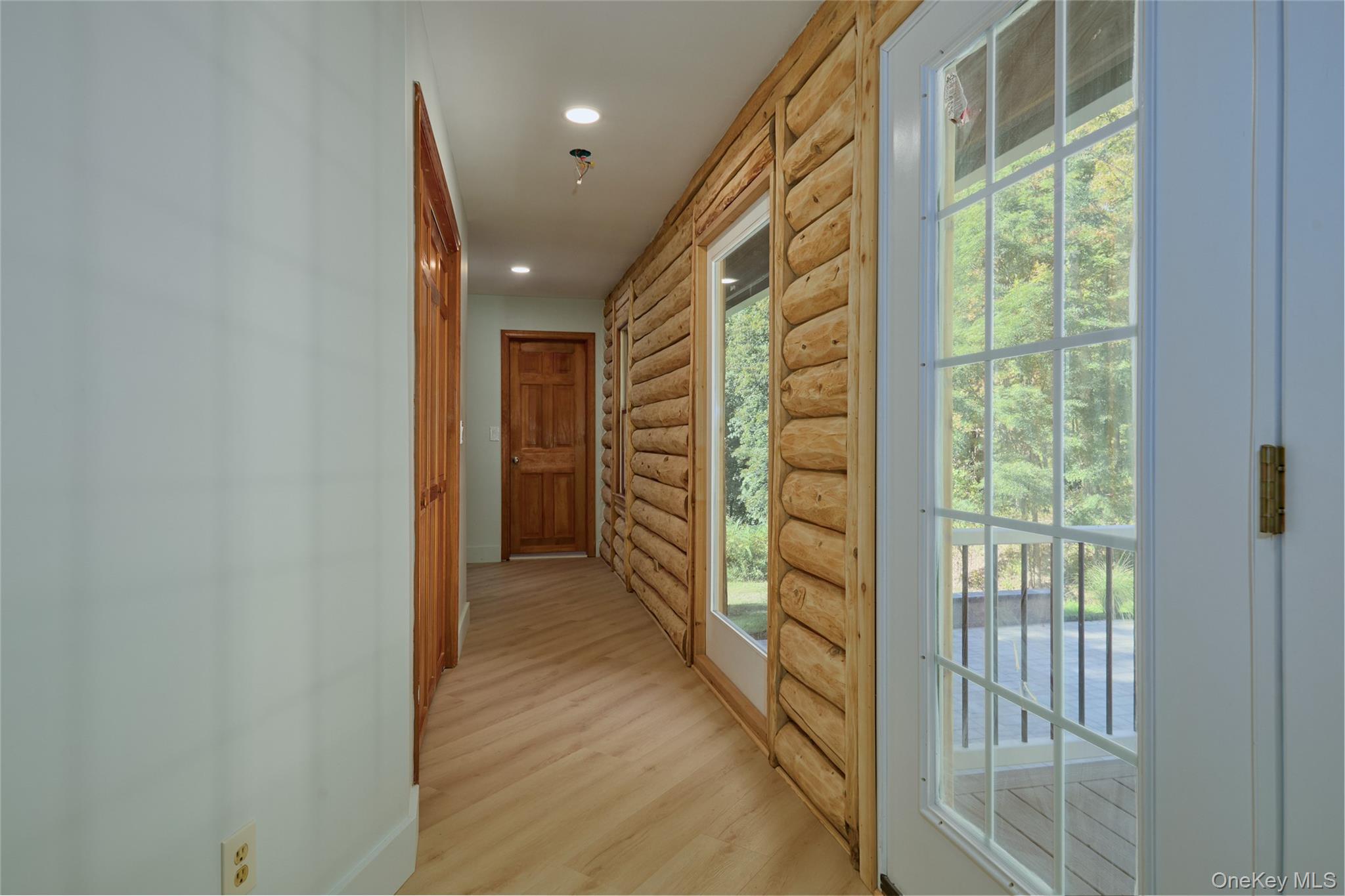 568 Oak Summit Road Millbrook, NY 12545 - Photo 34 of 50 Hallway with light wood-style floors, recessed lighting, and log walls