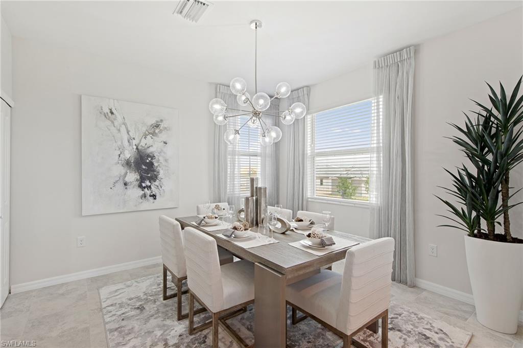 6008 Ellerston Way Avenue, Unit 1021 Immokalee, FL 34142 - Photo 18 of 50 Dining area featuring baseboards and a chandelier