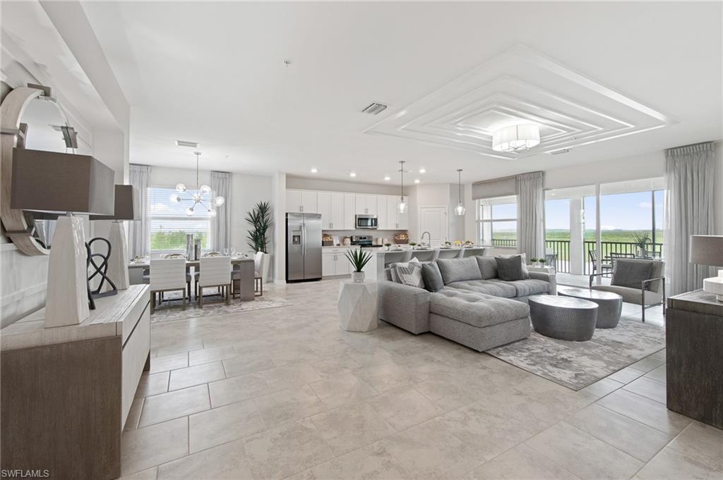 6008 Ellerston Way Avenue, Unit 1021 Immokalee, FL 34142 - Photo 2 of 50 Living room with a chandelier, plenty of natural light, light tile patterned floors, and recessed lighting