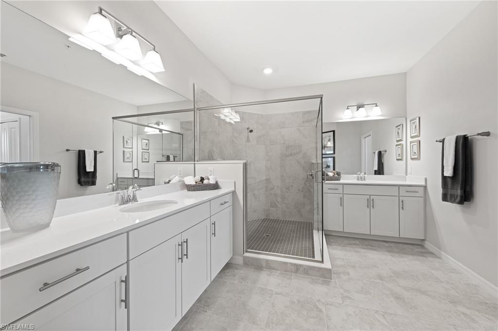 6008 Ellerston Way Avenue, Unit 1021 Immokalee, FL 34142 - Photo 35 of 50 Bathroom with two vanities, a stall shower, and light tile patterned floors