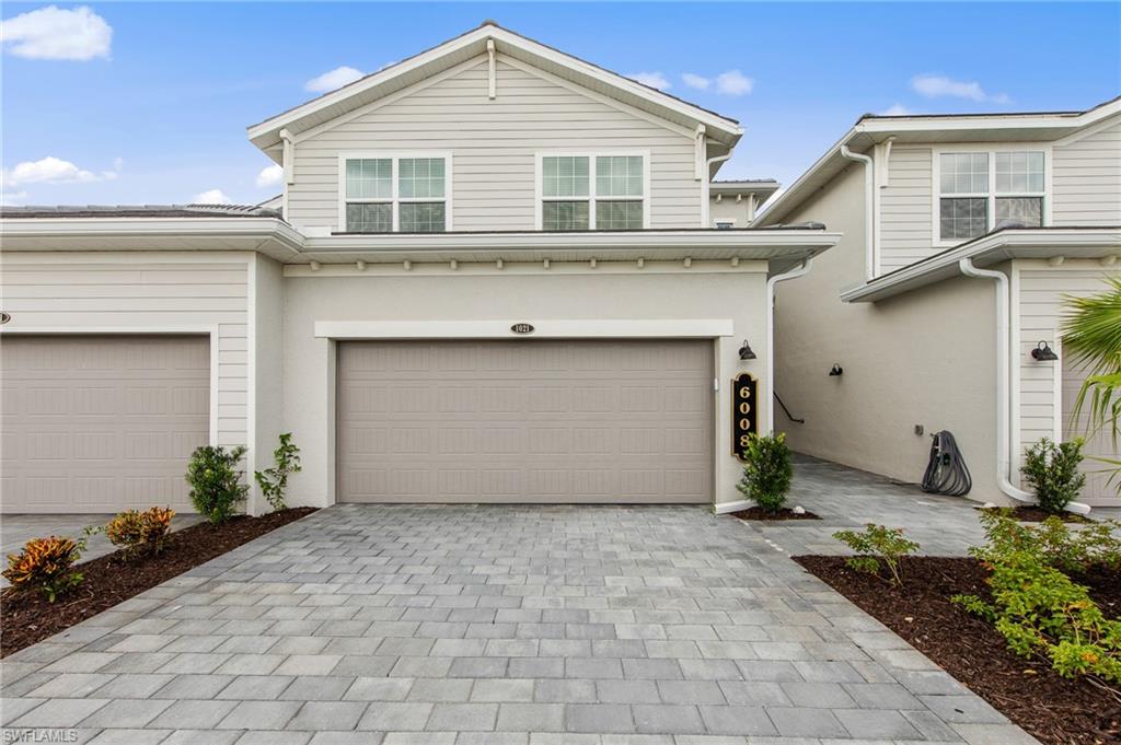 6008 Ellerston Way Avenue, Unit 1021 Immokalee, FL 34142 - Photo 38 of 50 Traditional home with decorative driveway, stucco siding, and an attached garage
