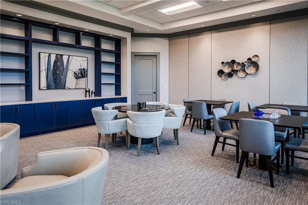 6008 Ellerston Way Avenue, Unit 1021 Immokalee, FL 34142 - Photo 50 of 50 Dining area featuring light colored carpet, built in features, and a decorative wall