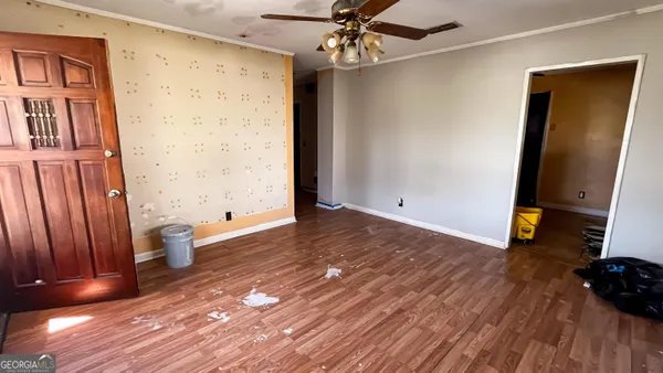 wooden floor in an empty room with a window