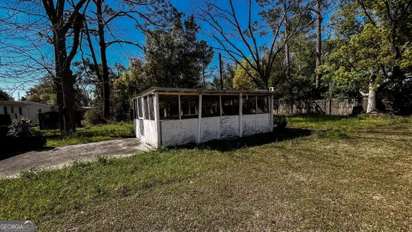 a view of a house with a yard and tree s