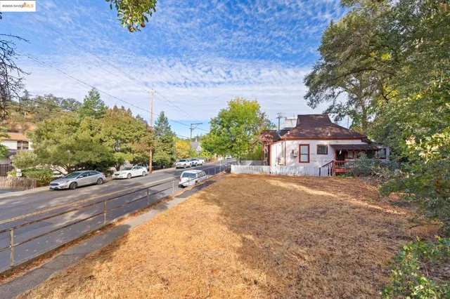 a view of a house with a yard and sitting area