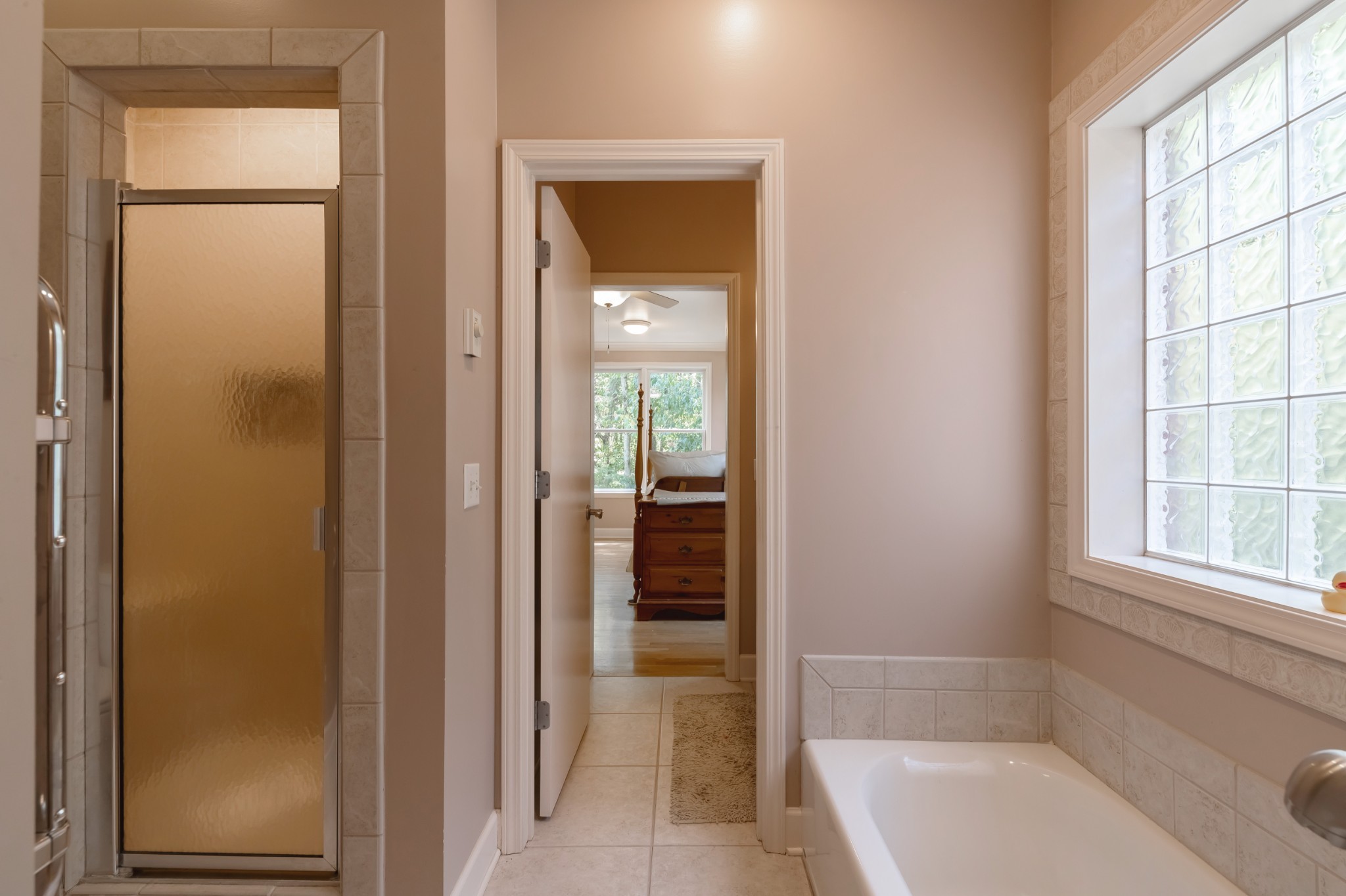 7650 Sleepy Summit Road Fairview, TN 37062 - Photo 20 of 30 a bathroom with a tub shower and a window