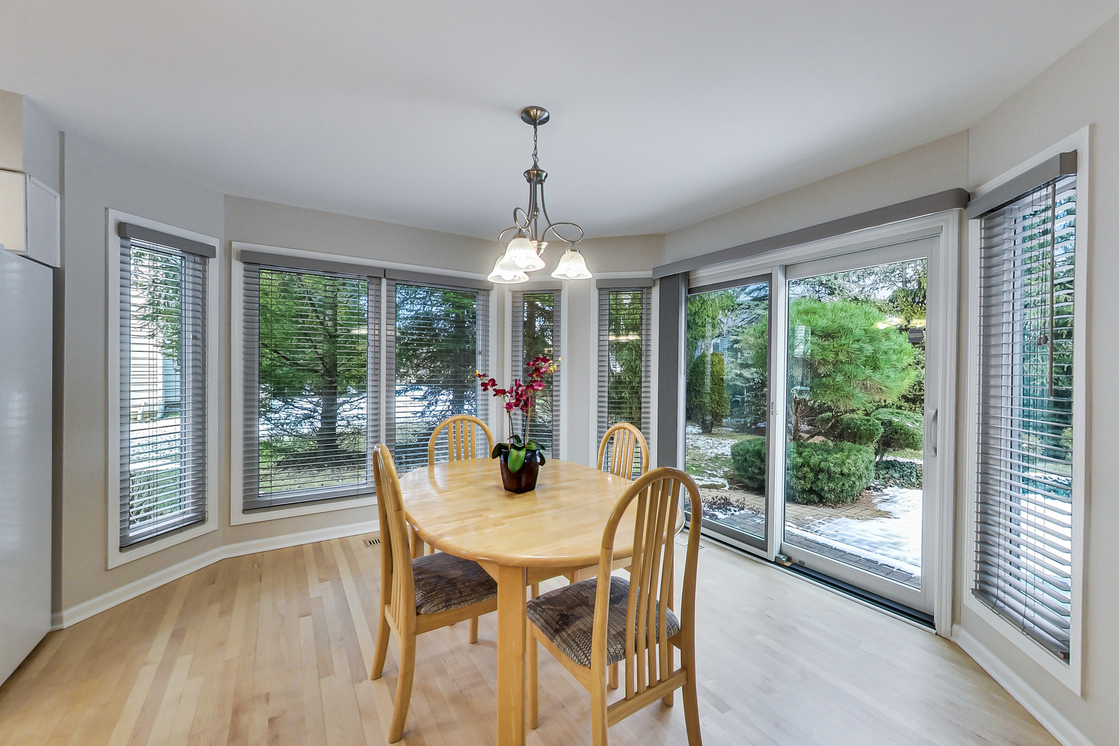 790 Edgemere Road Buffalo Grove, IL 60089 - Photo 14 of 42 a view of a dining room with furniture large windows and wooden floor