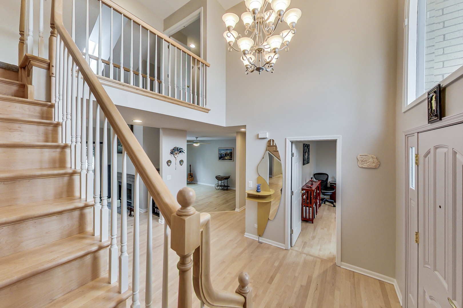 790 Edgemere Road Buffalo Grove, IL 60089 - Photo 4 of 42 a view of staircase with lots of frames on wall and a chandelier