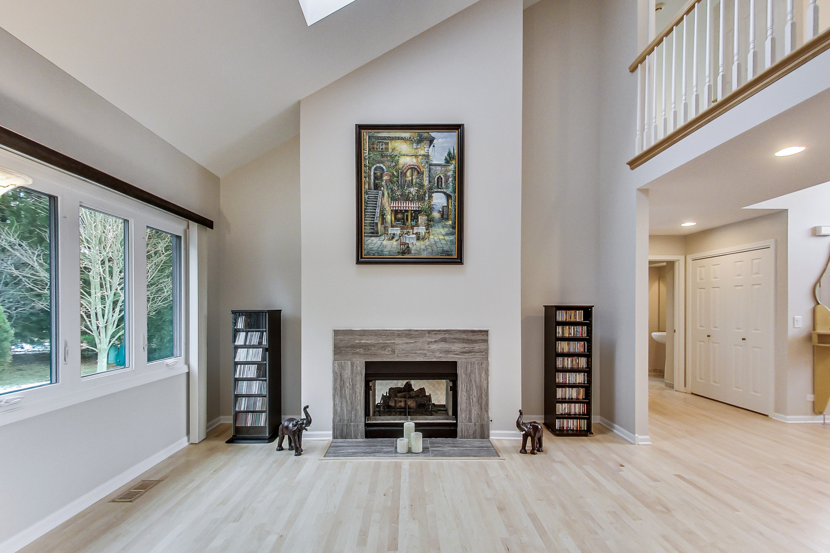 790 Edgemere Road Buffalo Grove, IL 60089 - Photo 8 of 42 wooden floor with fireplace and windows in an empty room