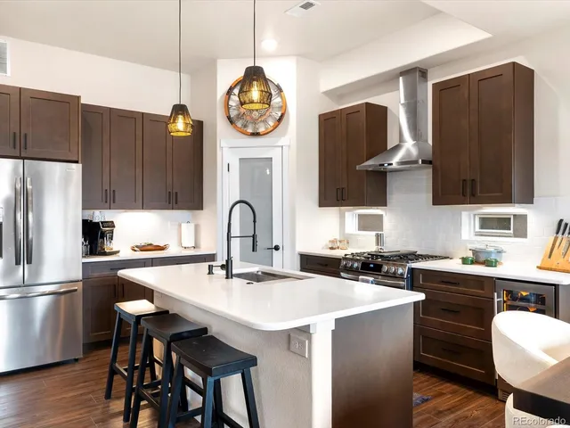 a kitchen with a sink cabinets and stainless steel appliances