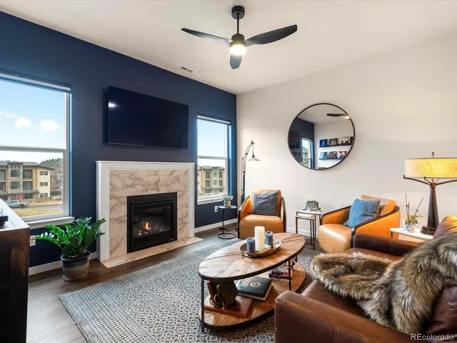 a living room with furniture and a fireplace