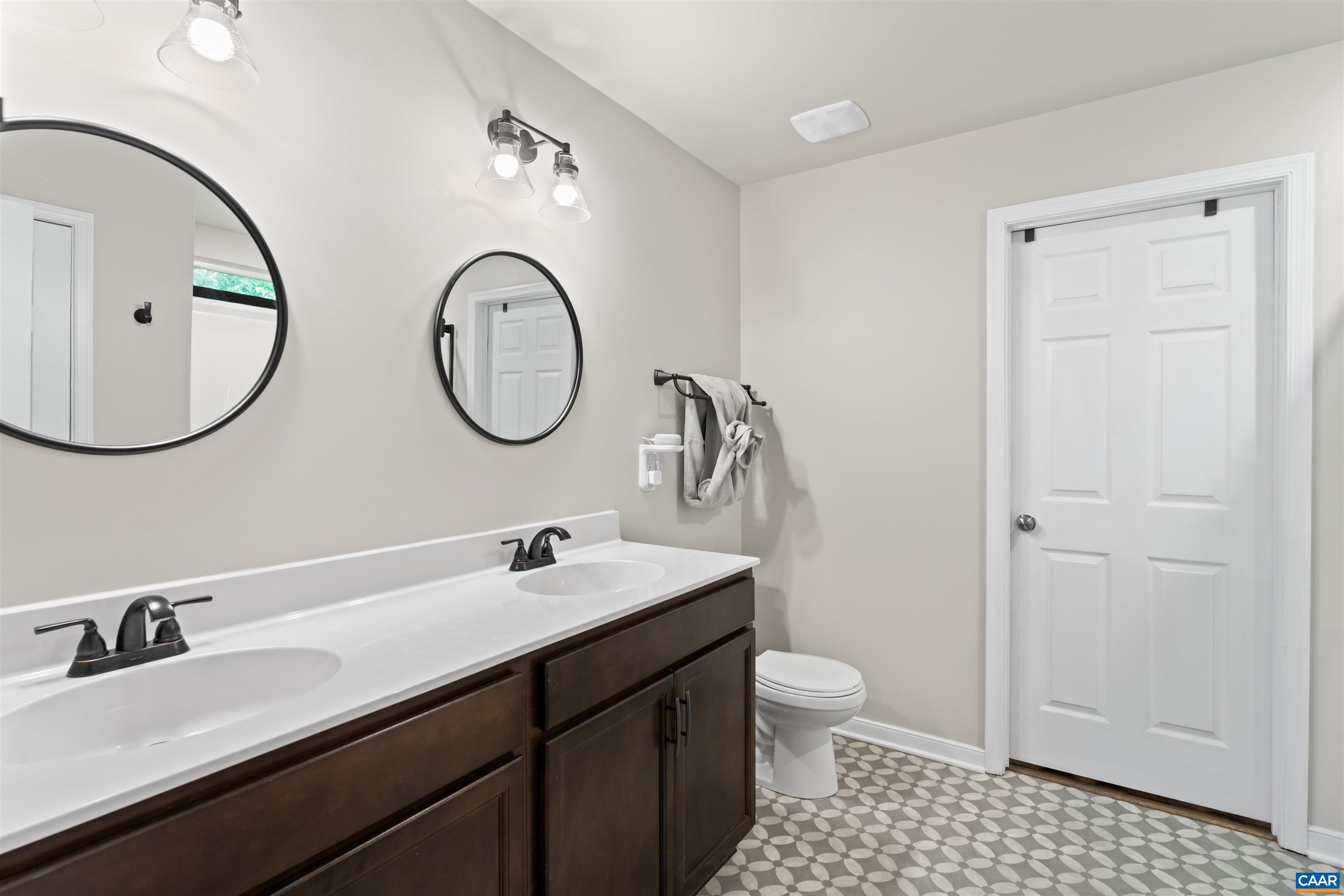 1760 Haden Martin Road Palmyra, VA 22963 - Photo 32 of 51 a bathroom with a double vanity sink mirror and toilet
