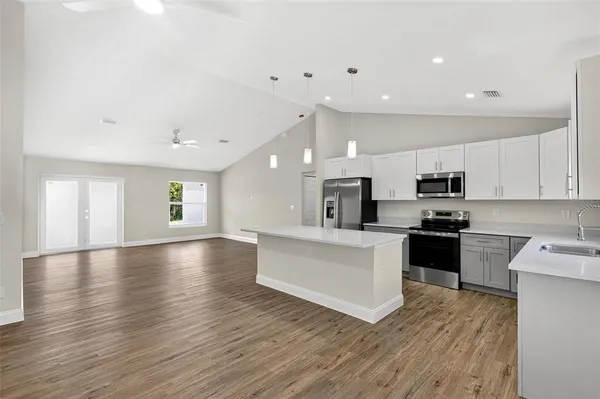a large kitchen with stainless steel appliances lots of counter top space and cabinets