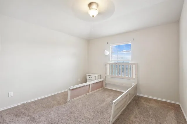 an empty room with cabinet and windows