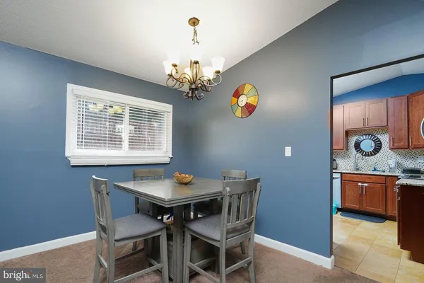 a view of a dining room with furniture and chandelier