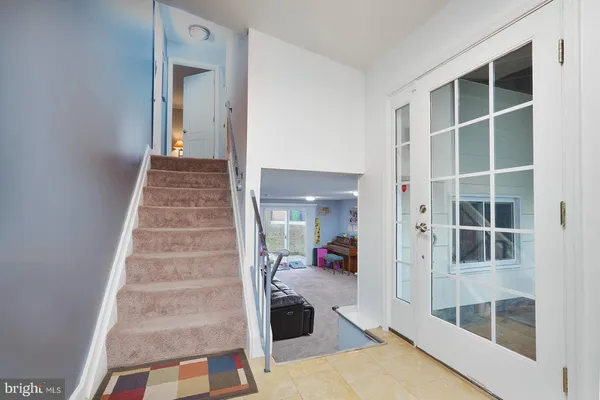 a view of a hallway with wooden floor and windows