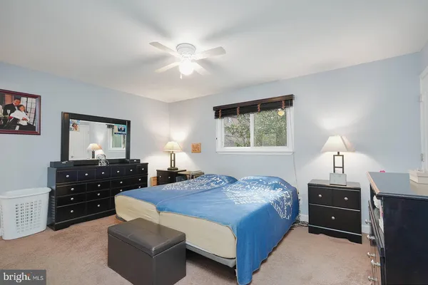 a bedroom with a bed and a dresser