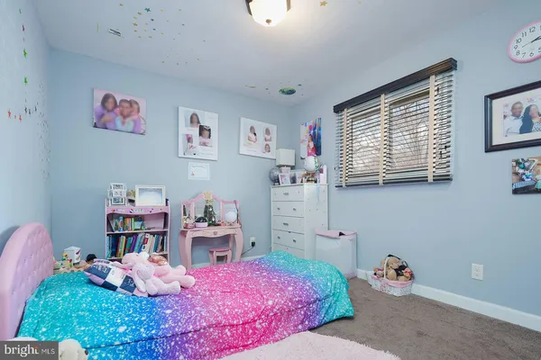 a bedroom that has a bed and a bookshelf in it
