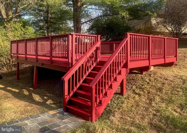 a backyard of a house with a small deck and a garden